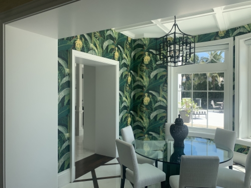 A dining room with palm figure wallpaper