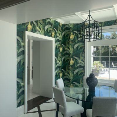 A dining room with palm figure wallpaper